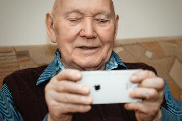 Older man looking at phone