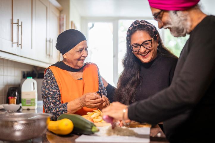 Lady helping her elderly parents prepare dinner