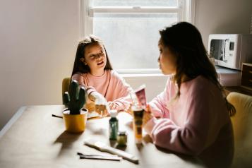 Young teenager helping her mother