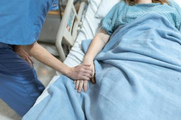 Person laying in hospital bed 