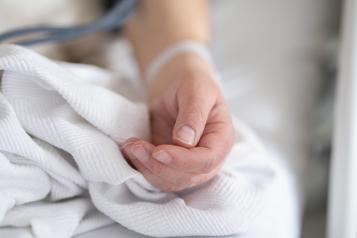 Image of an arm on bed sheets