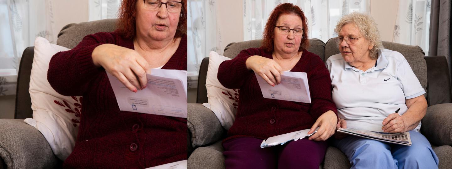 Two ladies reading a letter 